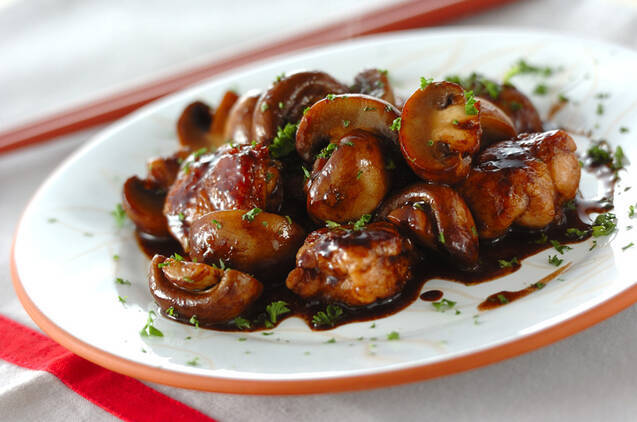 白い皿に盛りつけられた鶏むね肉とマッシュルームのバルサミコソテー