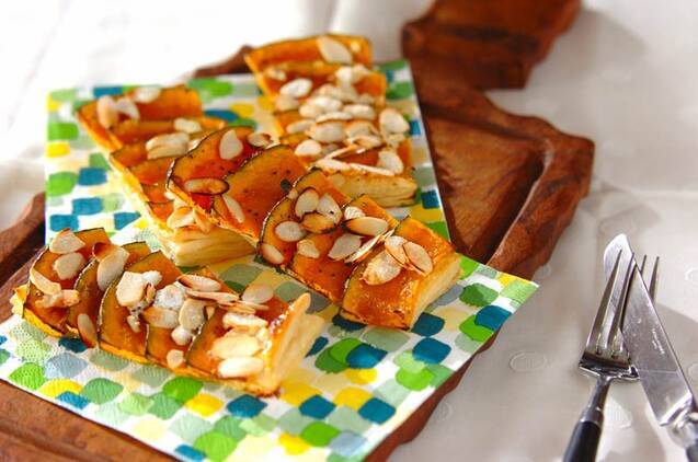 カラフルなペーパーが敷かれたウッドプレートに置かれた、ペッパーパンプキンパイ