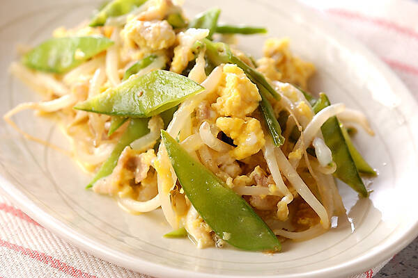 白っぽい楕円皿に盛られた、絹さやとモヤシの卵とじ