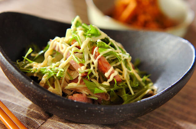 黒い器に入ったチャーシューと水菜のサラダ