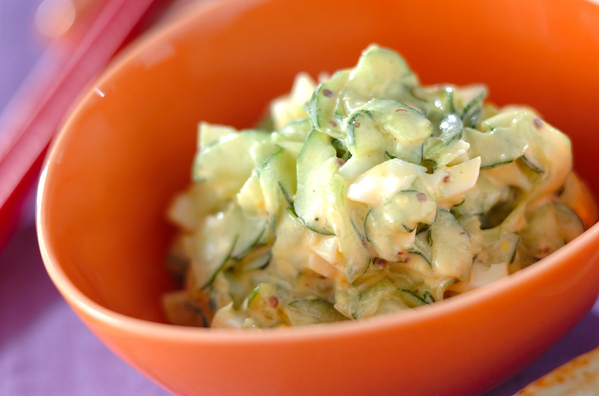 オレンジのお皿に盛られたきゅうりと卵のサラダ