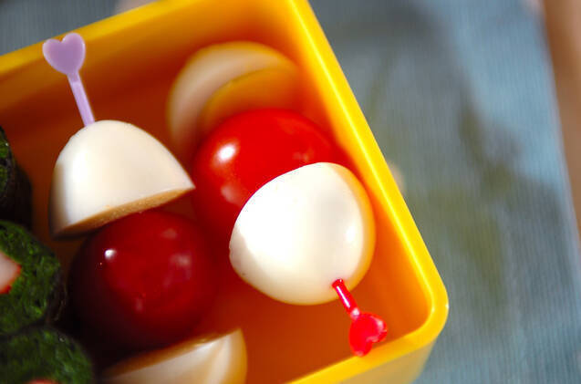 赤いピックにささったうずら卵とミニトマト串