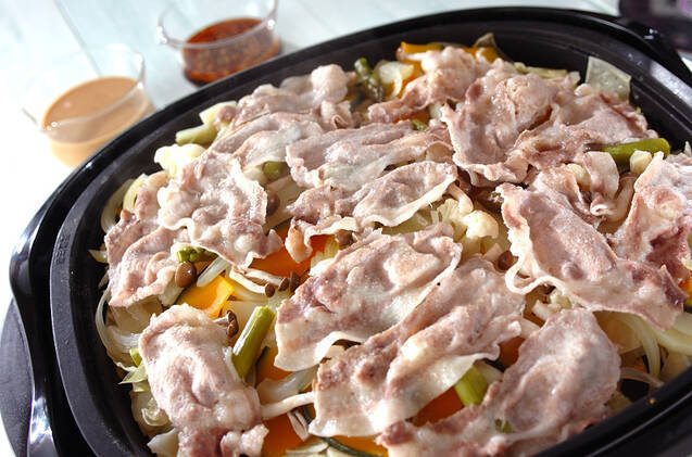 アスパラ、かぼちゃ、シメジなどの上に豚肉を広げ、ホットプレートで蒸し焼きにしたひと品。ゴマダレやピリ辛ダレでいただく。