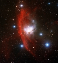 赤く輝く水素ガスに囲まれた青白い反射星雲NGC 1788