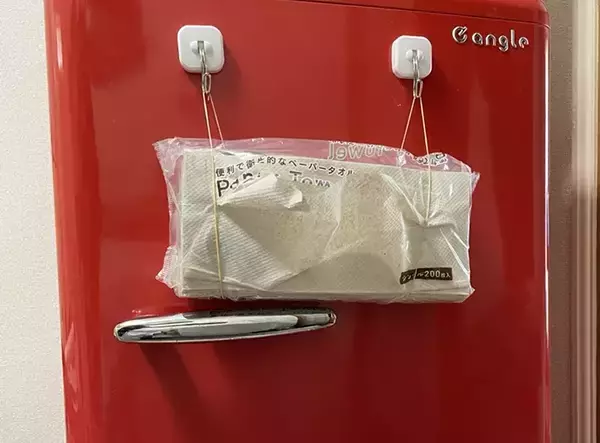 「キッチンペーパー、まだ棚に入れてる？　マグネットフックと輪ゴムを合わせる裏ワザに「片手で取り出せる」「つけ替えも簡単」」の画像