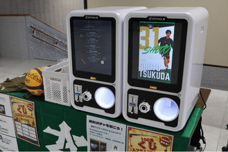 3人制プロバスケットボールチーム「AZ SAITAMA」の試合会場にデジタルサイネージ搭載ガチャマシン2台を提供　SNSフォロー施策と限定グッズ企画を運用支援