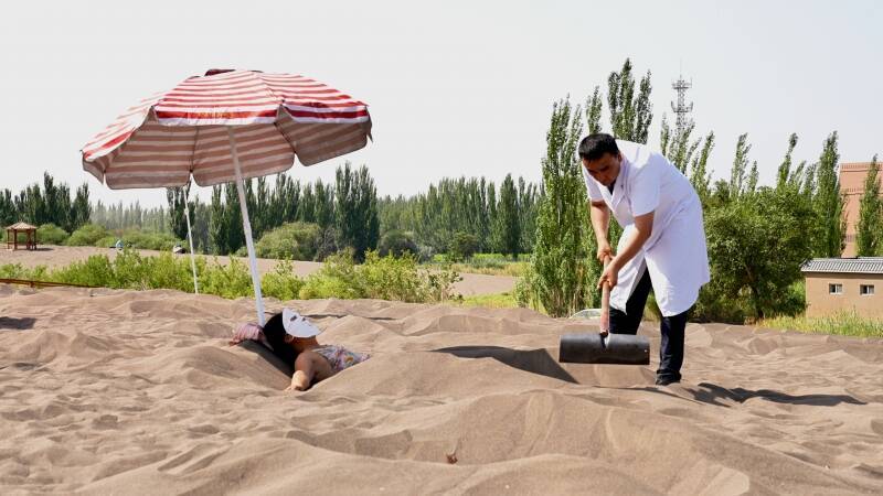 新疆の砂浴が中国国内外の観光客の間で人気に―中国メディア