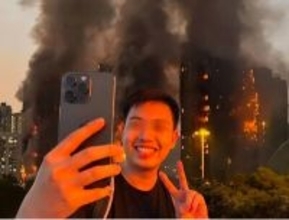 香港火災をバックに笑顔で自撮り、男が拘束される