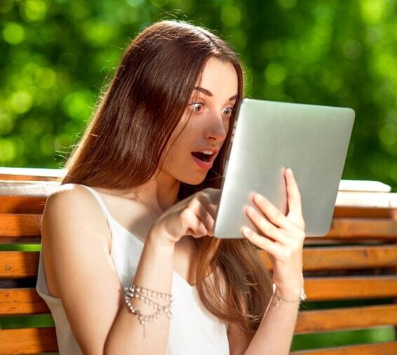 Young woman with digital tablet in the park