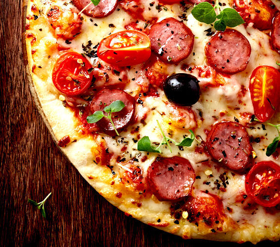 Pizza with pepperoni and cherry tomatoes