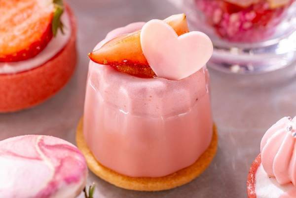 春のうららかな日差しのなか、淡いピンク色の桜と赤く艶やかな色の苺を楽しむコンラッド東京のアフタヌーンティー