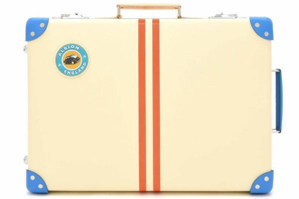 グローブ・トロッター“英国の家族旅行”着想のストライプ柄スーツケース、白い砂浜×青い海カラー