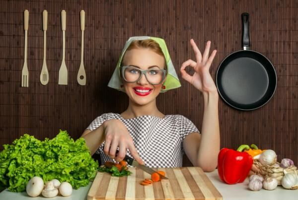 Happy woman cook with okay sign cut carrot-vintage concept