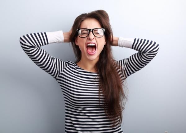 Anger young business woman in glasses strong screaming with wild