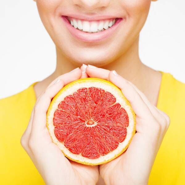 Young brunette woman with grapefruit