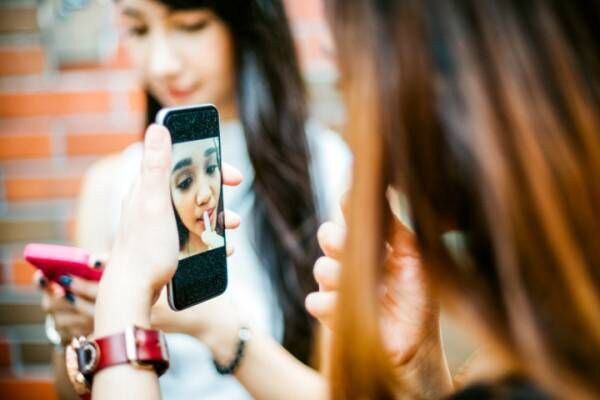 Japanese Teenage Girls using Smartphone as Vanity Mirror