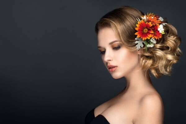 Beautiful woman portrait with flowers in hair. Autumn bride