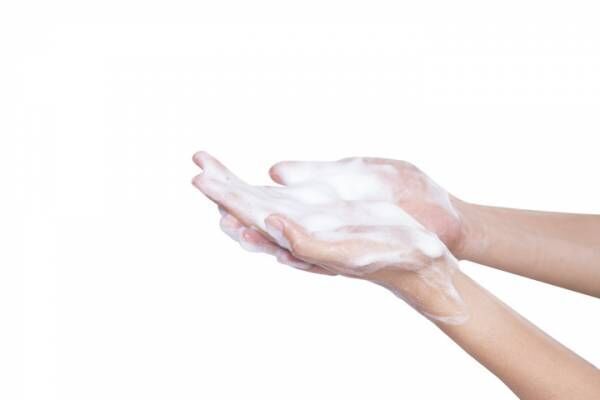 foam cream sample on hand, isolated on white background