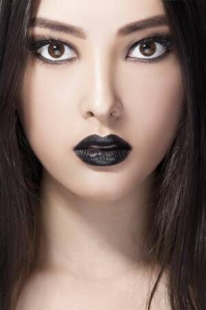 Woman beauty fashion portrait with black lips in studio. Asian