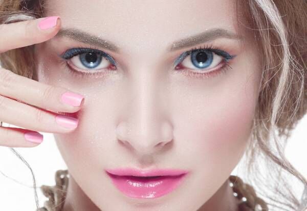 Beautiful woman young model with pink lips and pink manicure