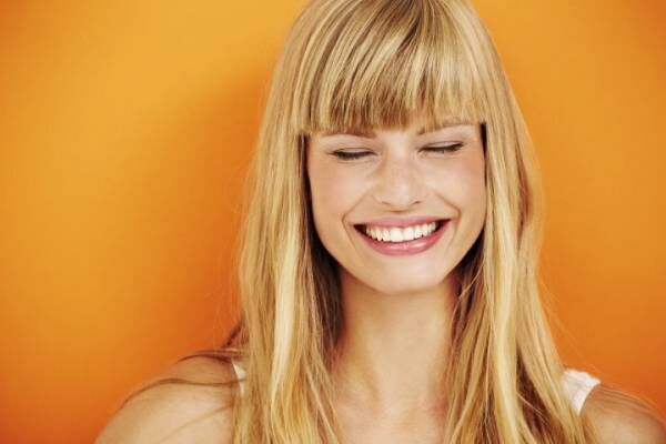 Young blond woman laughing