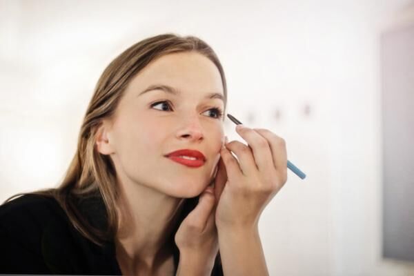 beautiful woman putting make-up on