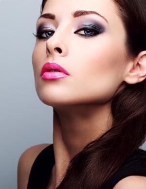 Beautiful woman with bright smokey makeup eyes and pink lipstick