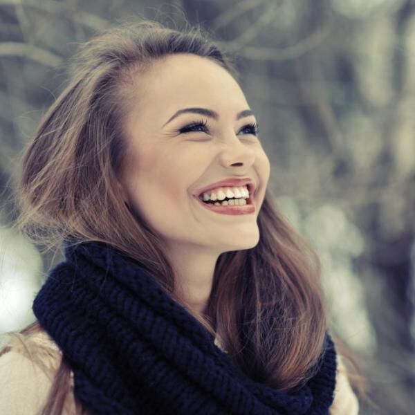 Young beautiful laughing girl in winter - close up
