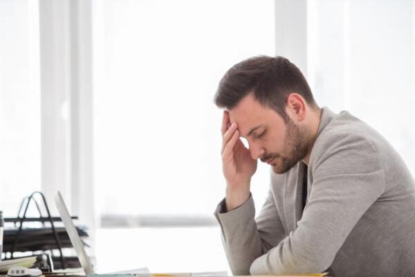 Man with headache at office
