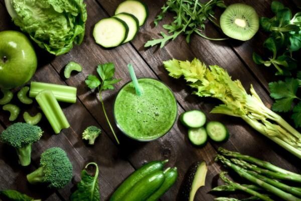 Detox diet concept: green vegetables on wooden table