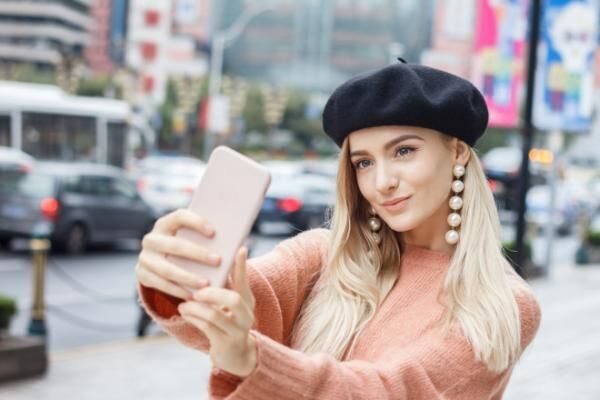 Beautiful woman taking pictures with smartphone