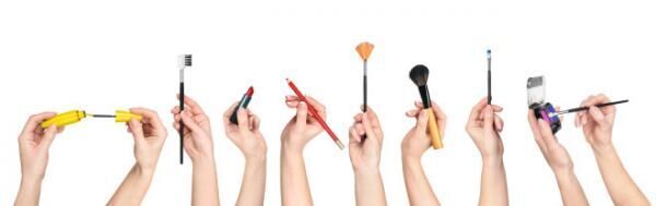 collection of hands holding tools for makeup