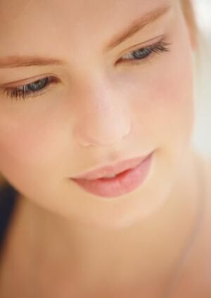 Close-up of a beautiful young woman looking down