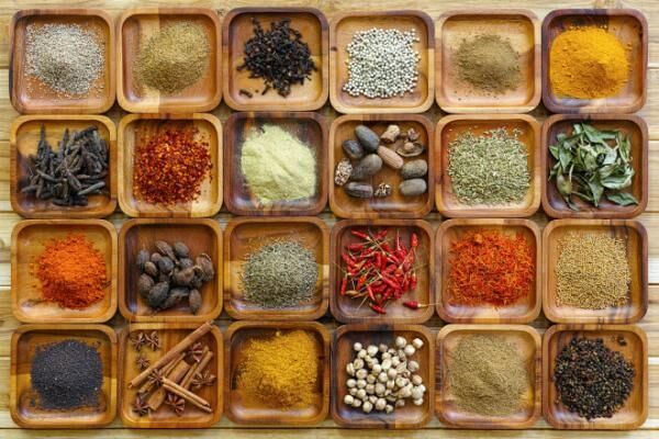 Indian spices in wooden trays.