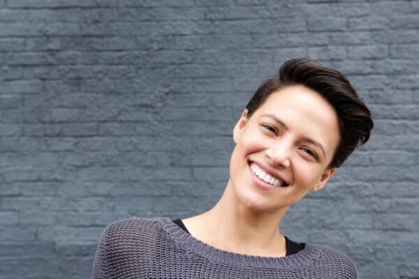 Close up smiling young woman with short hair