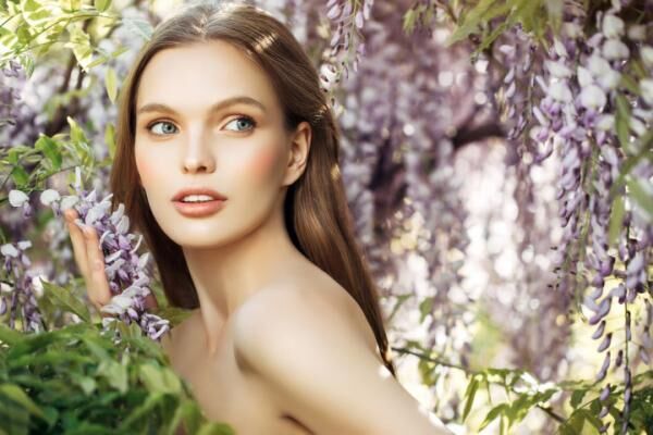 Beautiful girl on the background of spring bush