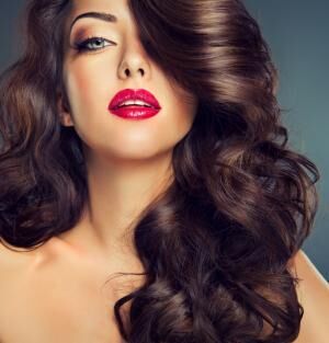 Beautiful model brunette with long curled hair. Luxury fashion style,
