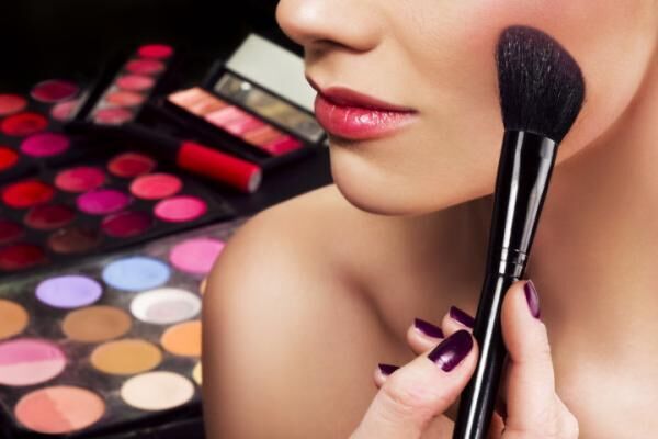 Makeup artist applying blusher