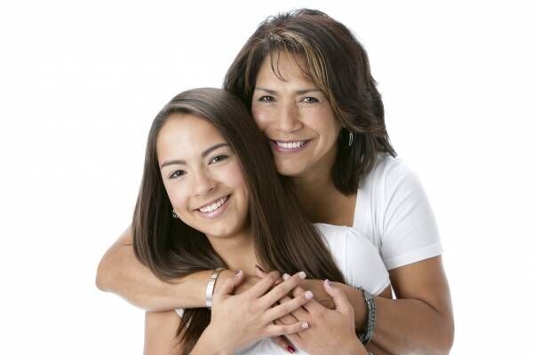 Real People: Head Shoulders Smiling Hispanic Mother and Teenage Daughter