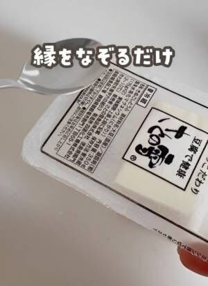 豆腐のパックの縁を熱したスプーンでなぞる様子