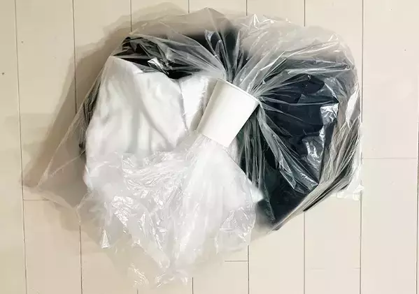いつものゴミ袋で服を圧縮！　紙コップを使って3秒でまとめる手順