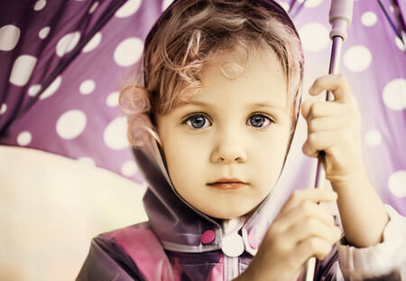 35559234 - little cute girl holding an umbrella, close up portrait