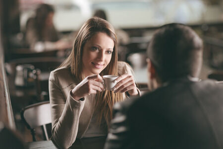 36918333 - young fashionable couple dating at the bar, she is having a coffee