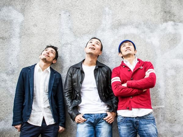 Three Japanese men standing and looking up