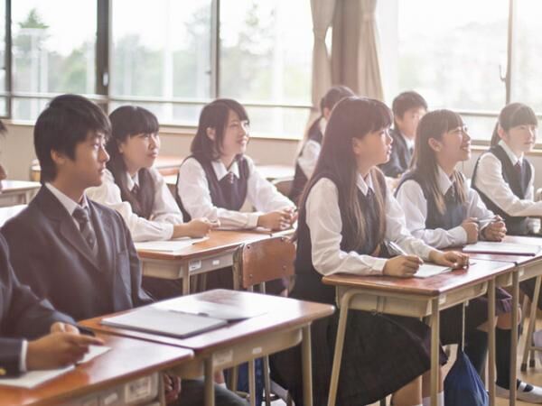 Japanese students listening to the teacher in the classroom