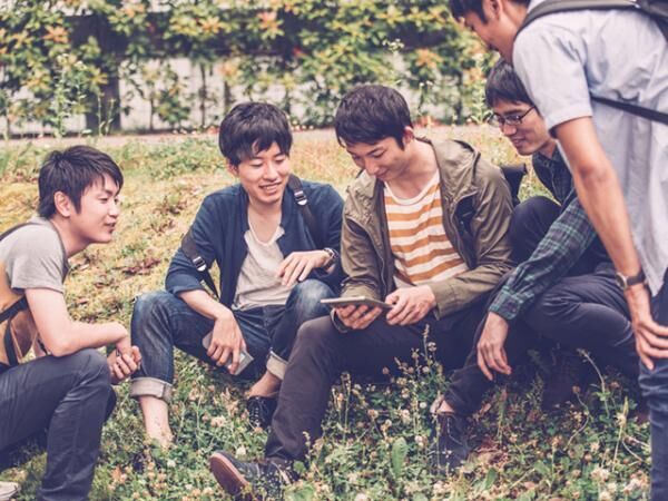 Five Japanese Students Using Digital Tablet, Campus Park, Kyoto, Japan