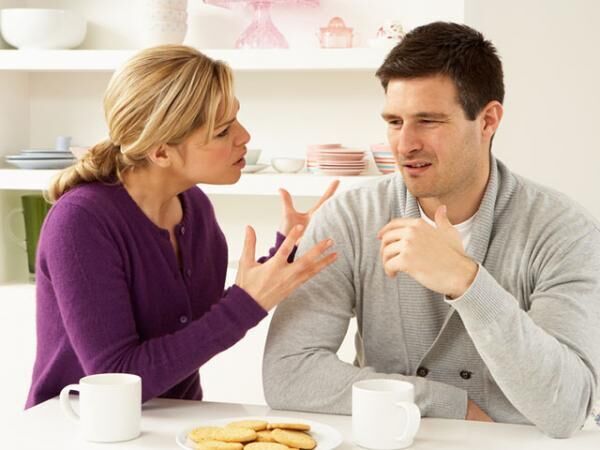 Young couple arguing at home over coffee