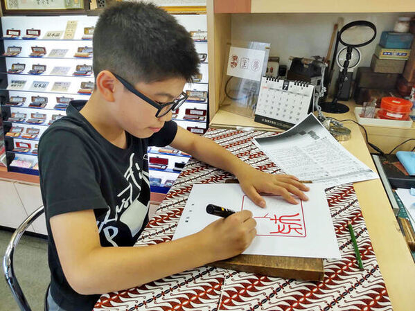 夏休みの宿題・自由研究に最適！7月13日より都内ハンコ専門店で「親子でワクワク 古代文字で自分の名前を書いてみよう！」を開講